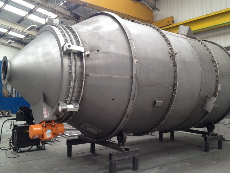 A large pressure vessel in a workshop environment