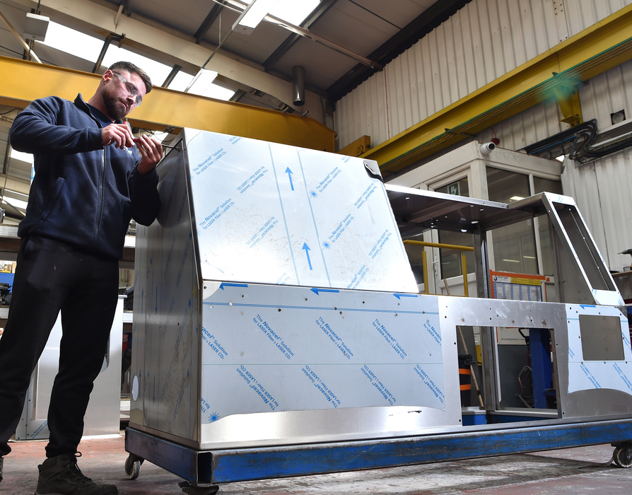 can making enclosure being assembled by a man